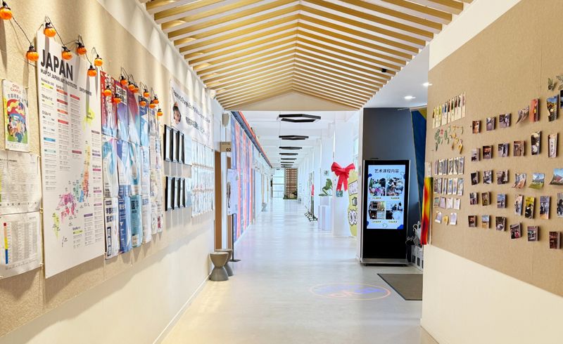 Student artwork lining the corridor of a teaching building at Boya