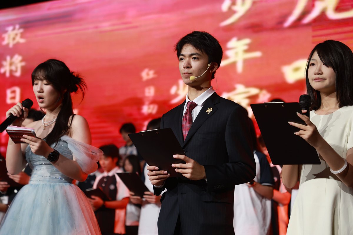 Student hosts presenting a campus ceremony