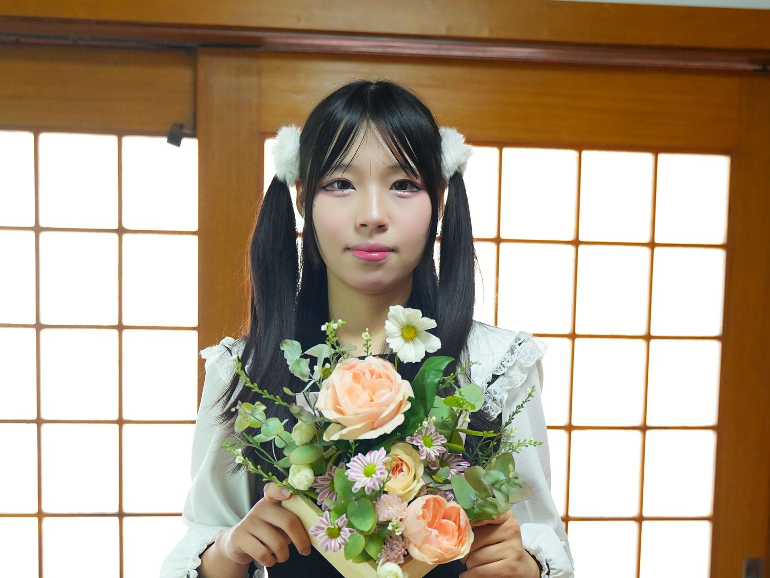 A student with her finished arrangement at a Japanese flower-arrangement class